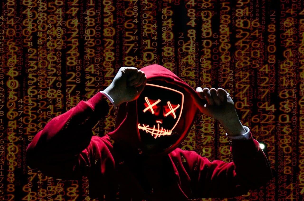 A hacker wearing red hoodie with a computerized face