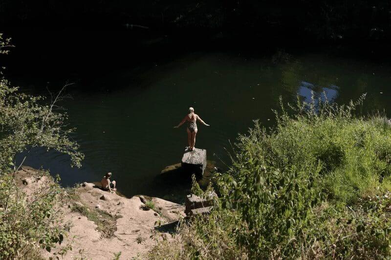 A woman about to dive into a lake in sheridan