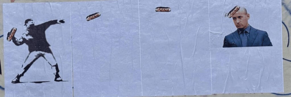 Banksy wall art of man throwing a sandwich at stephen miller