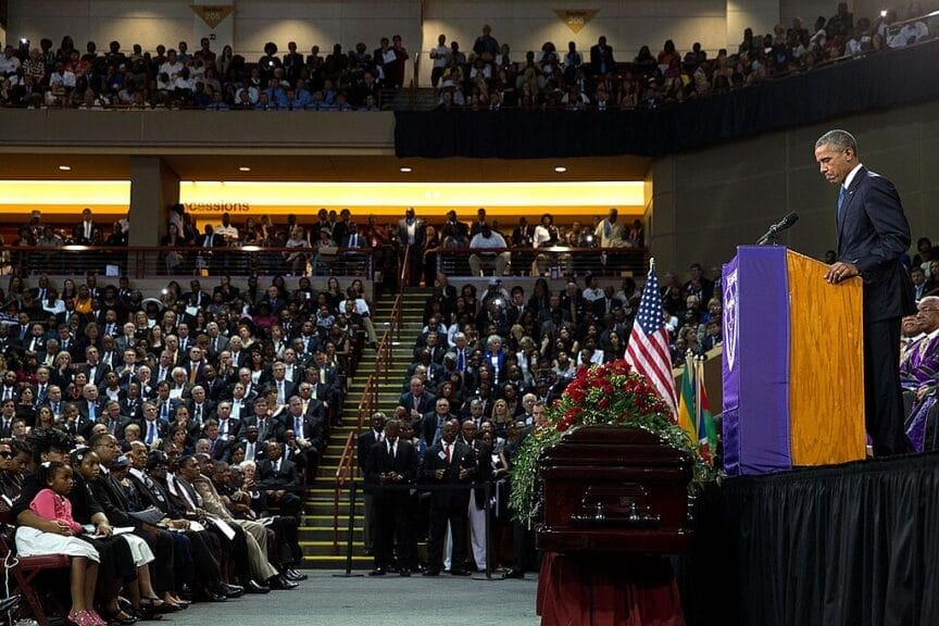 President barack obama gives a eulogy at the funeral of one of the victims of far-right extremist violence after dylann roof shot and killed multiple black members of a bible study in a south carolina church.