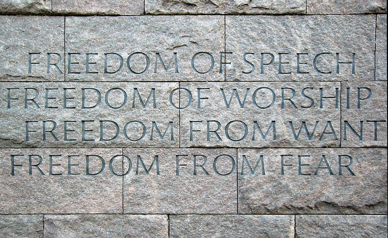Photo of a wall with the "fouren freedoms" at the franklin delano roosevelt memorial, washington dc.