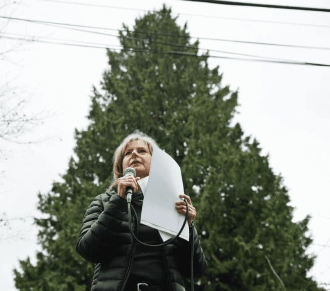 Woman speaking at outdoor tree protection event