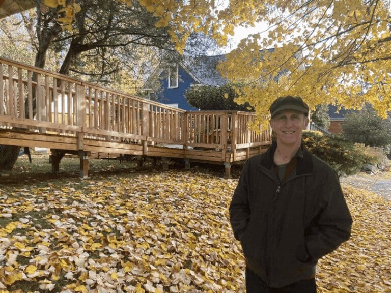 Tree protection. Woman standing in her yard