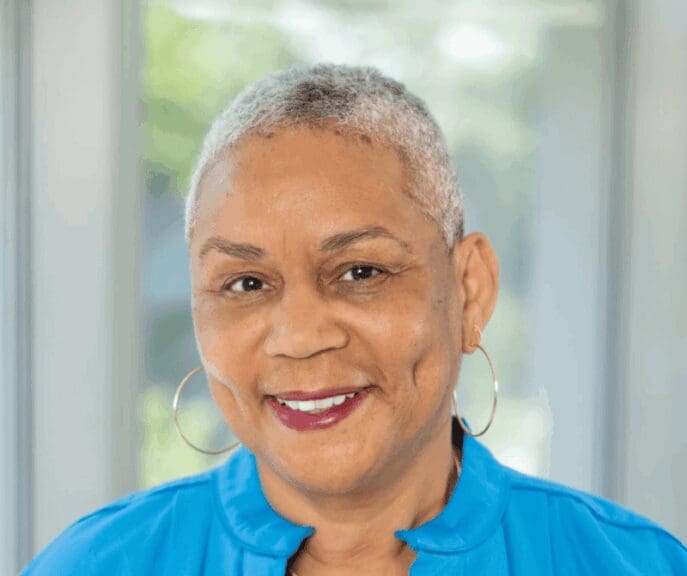 Idaho prison guards story black woman with short gray hair wearing a bright blue shirt.