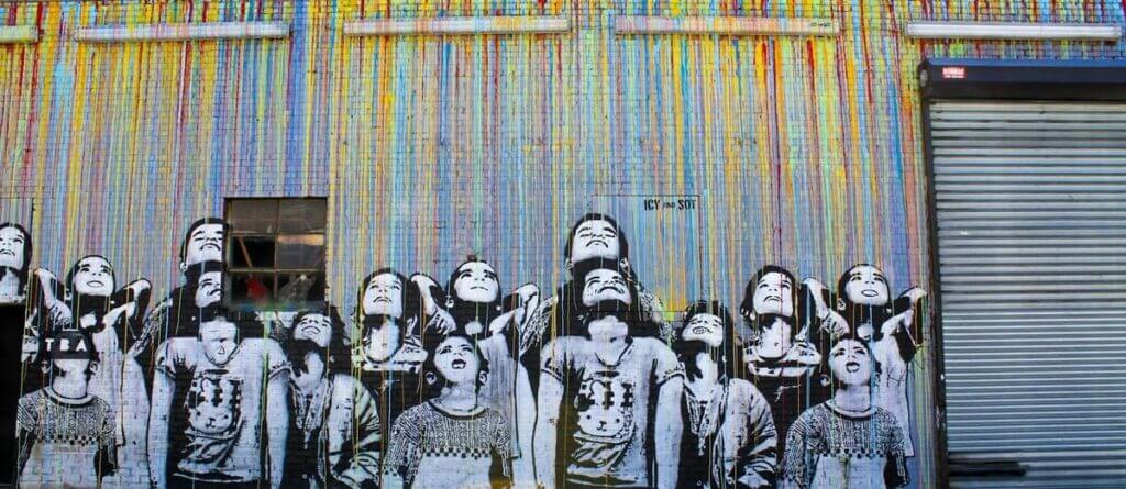 Don't look up. Colorful fence with drawing of children all looking up.