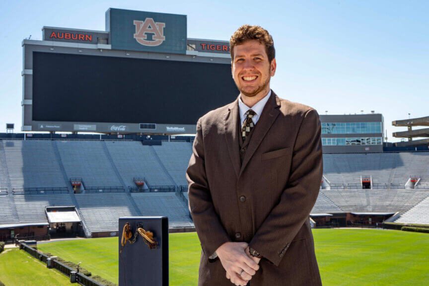 man inside bryant denny Man wearing a suit standing in a football stadium