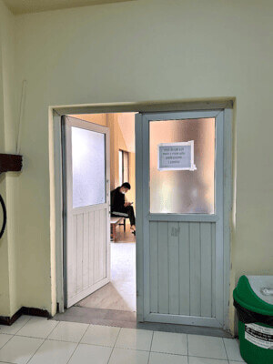 Migrant worker sitting in waiting room