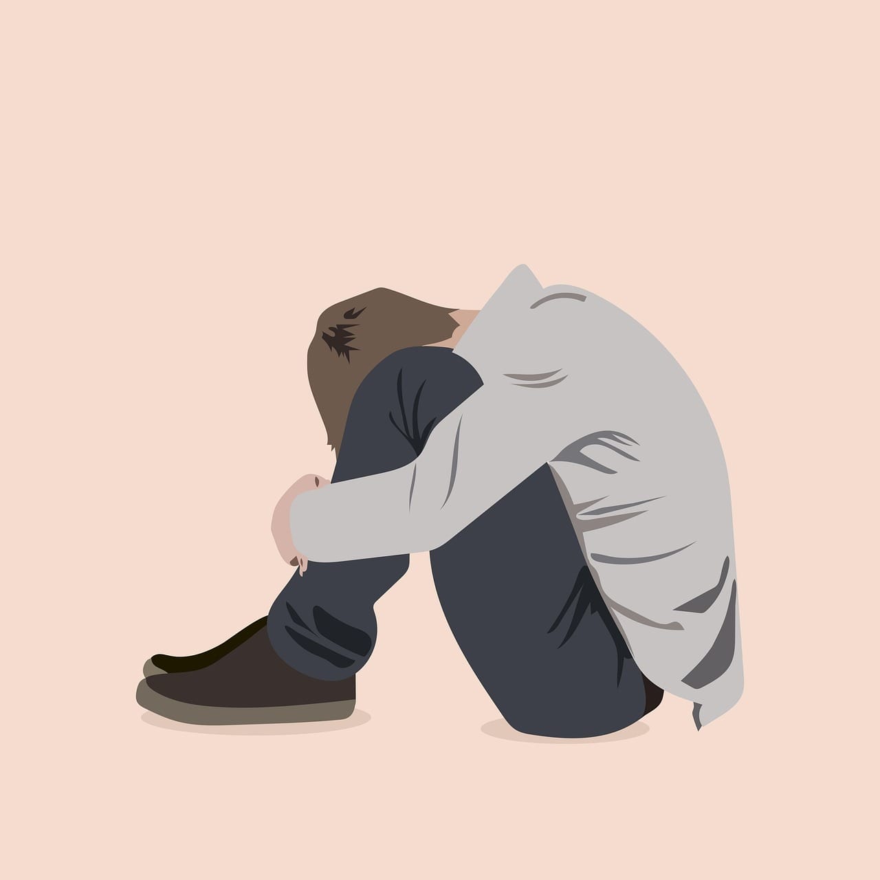 Kgbtq mental health resources. Illustration if a young man sitting on the floor with his head between his knees