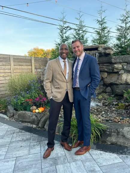 Men wearing suits posing together. Great looking couple.