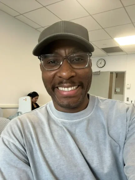 Hiv anxiety in dating. Handsome man in a baseball cap and glasses smiling