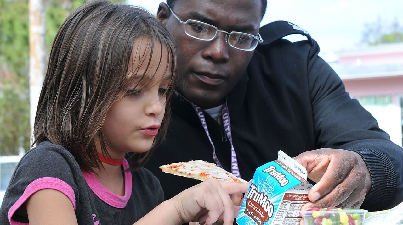 Sailor helps student solve riddle on school lunch milk carton