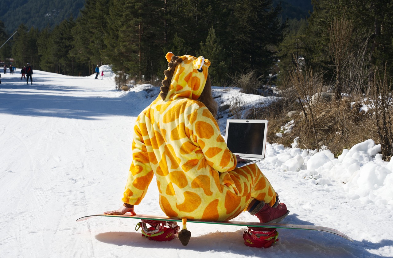 Write for us image of a woman dressed up as a giraffe on a snowboard