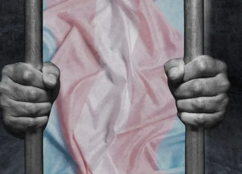Trans women in prison. Illustration of jail cell bars and a person holding onto bars wearing t-shirt with trans support colors