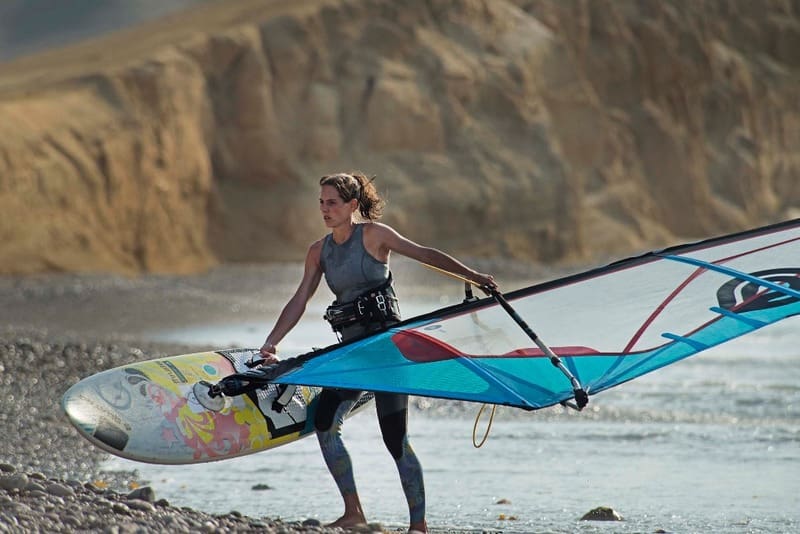 woman windsurfer Windsurfing champion carolina buteich holding her windsurfing board