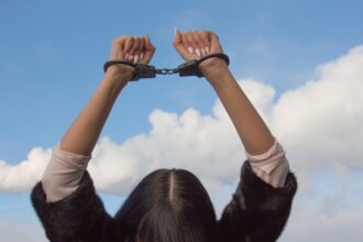 Civil rights violations woman in handcuffs. Abortion is homicide
