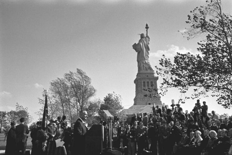 Lyndon johnson at the base of the statue of liberty on oct. 3, 1965, before signing the immigration and nationality act, which prohibited racial discrimination in the immigration process and repealed quotas heavily favoring immigration from northern and western europe.