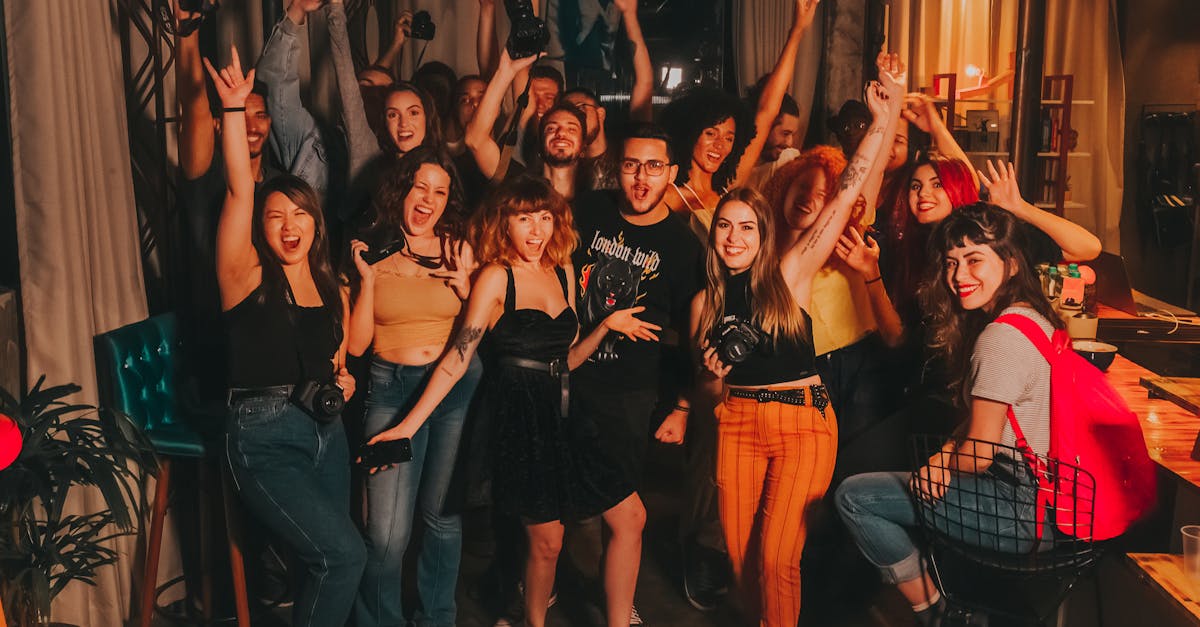 pexels photo 3856042 3856042 High angle of excited young diverse friends in casual outfits with arms raised yelling happily while celebrating project success in modern workspace
