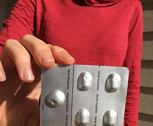 Hand holding abortion pills women's rights
