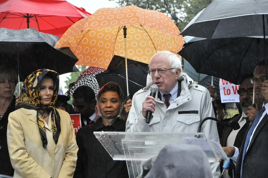 Bernie sanders speaking next to jesse jackson