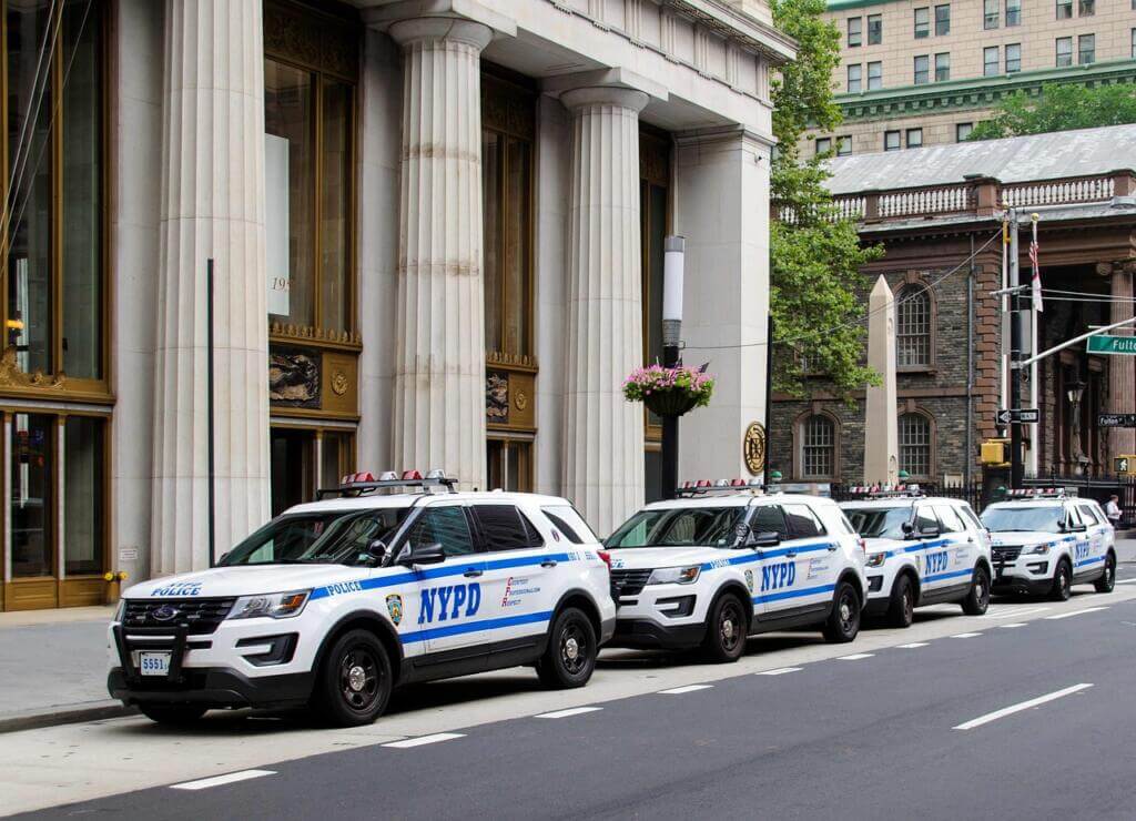 NYPD vehicles parked along the street in the city