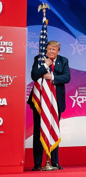Fascist president hugging the american flag