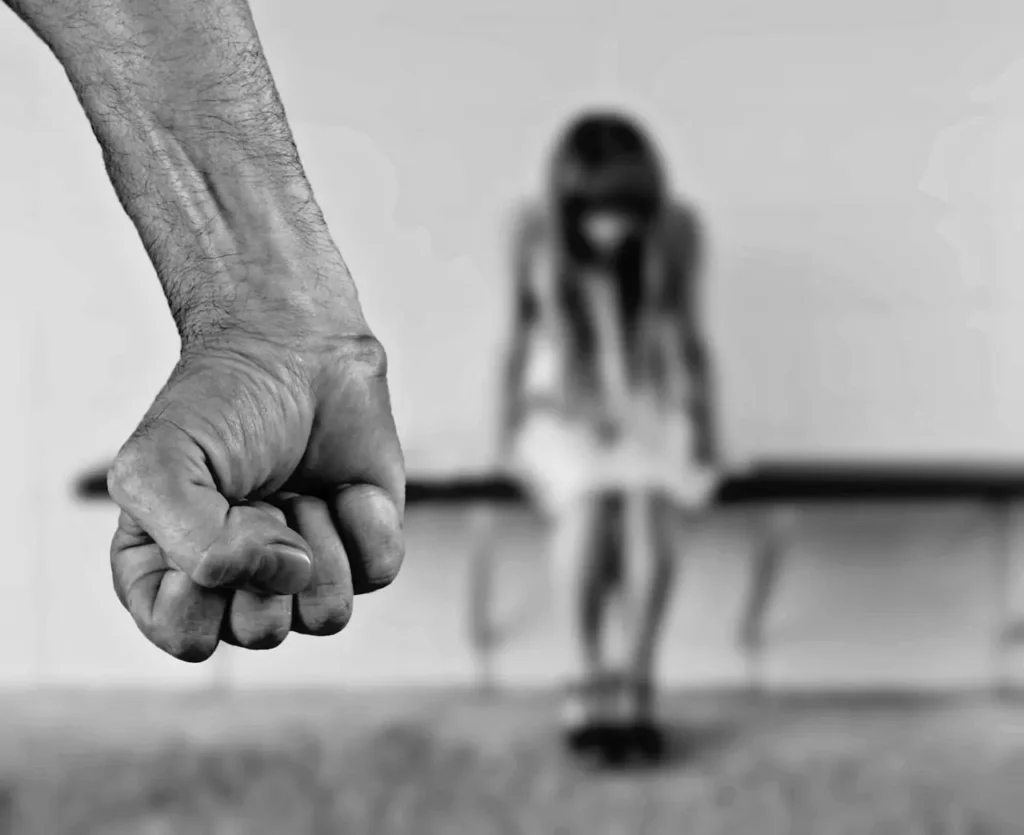 domestic abuse alexa Black and white photo of a man’s fist and a woman in a blurred background