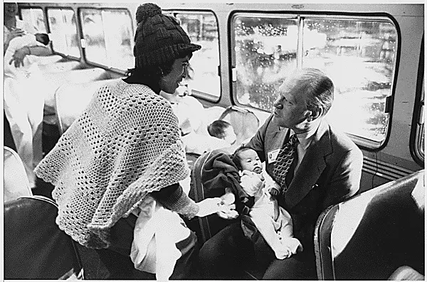 ford refugee woman baby This photograph depicts president gerald r. Ford talking to a woman refugee while holding a vietnamese baby on an united states air force bus. The president greeted the refugees of the republic of vietnam at a california airbase.