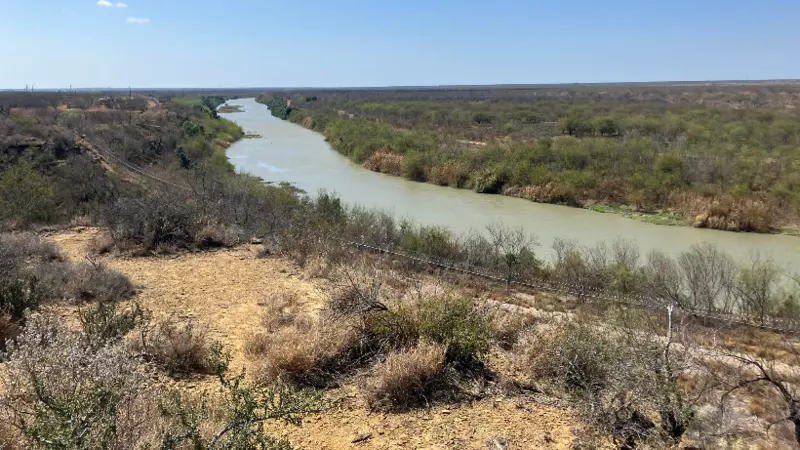 rio grande buoy project A view of the rio grande in zapata county, texas, where customs and border protection plans to install cylindrical buoys. Border fencing is visible on the banks of the river.