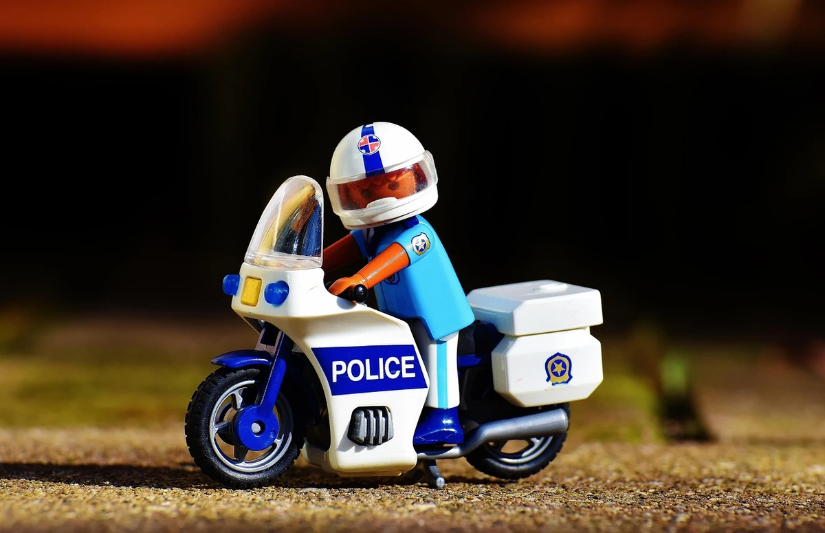 Lego police officer on a motorcycle represents ice posed as police officers