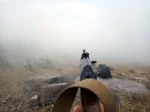 Rifle aimed in the fog in nature. Kurds