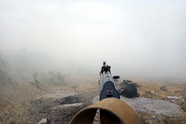 Rifle aimed in the fog in nature. Kurds