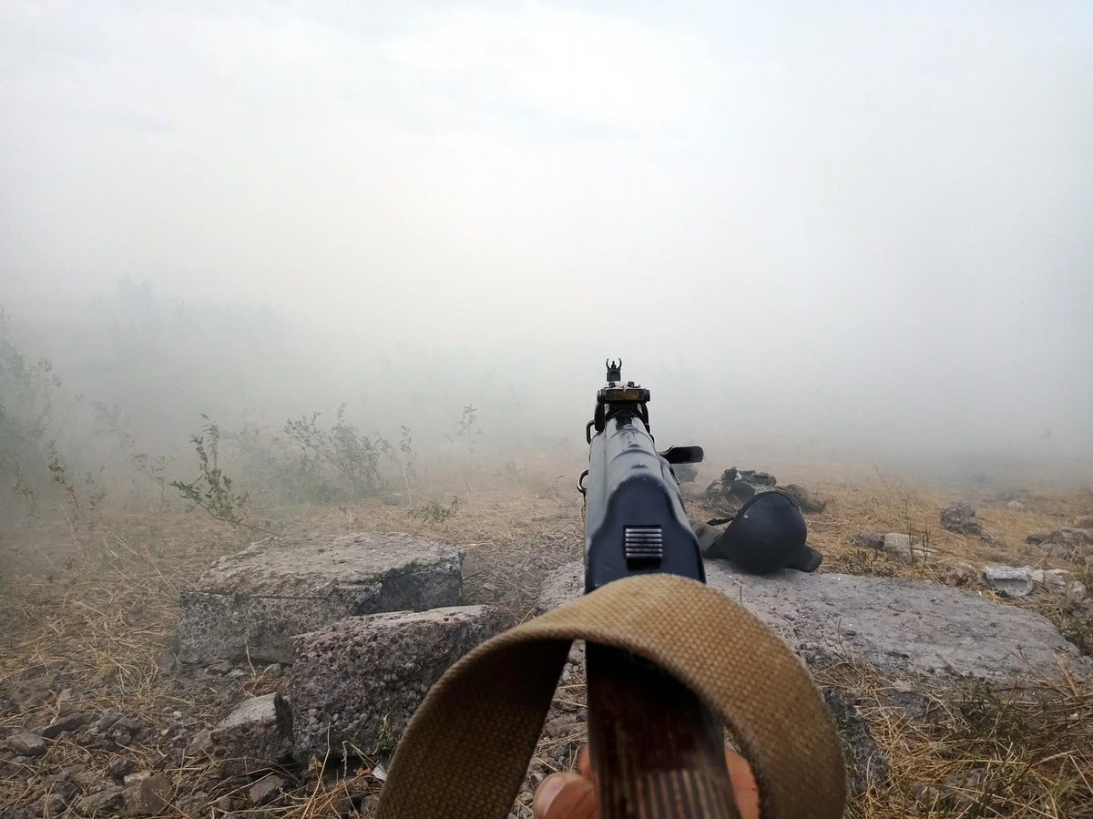 Rifle aimed in the fog in nature. Kurds