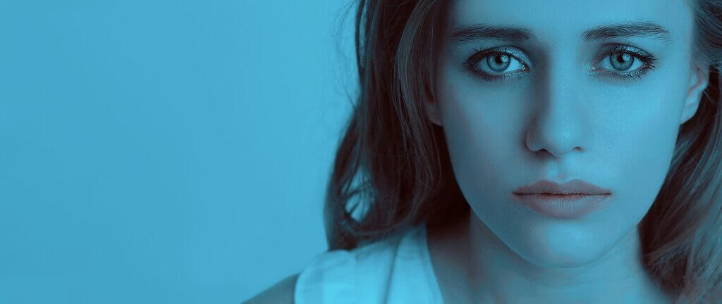 woman’s face on a blue background. Churches with female pastors are banned