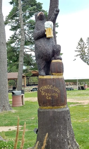 Wooden bear carving holding a mug of beer at the Minocqua Brewing Company in Wisconsin.